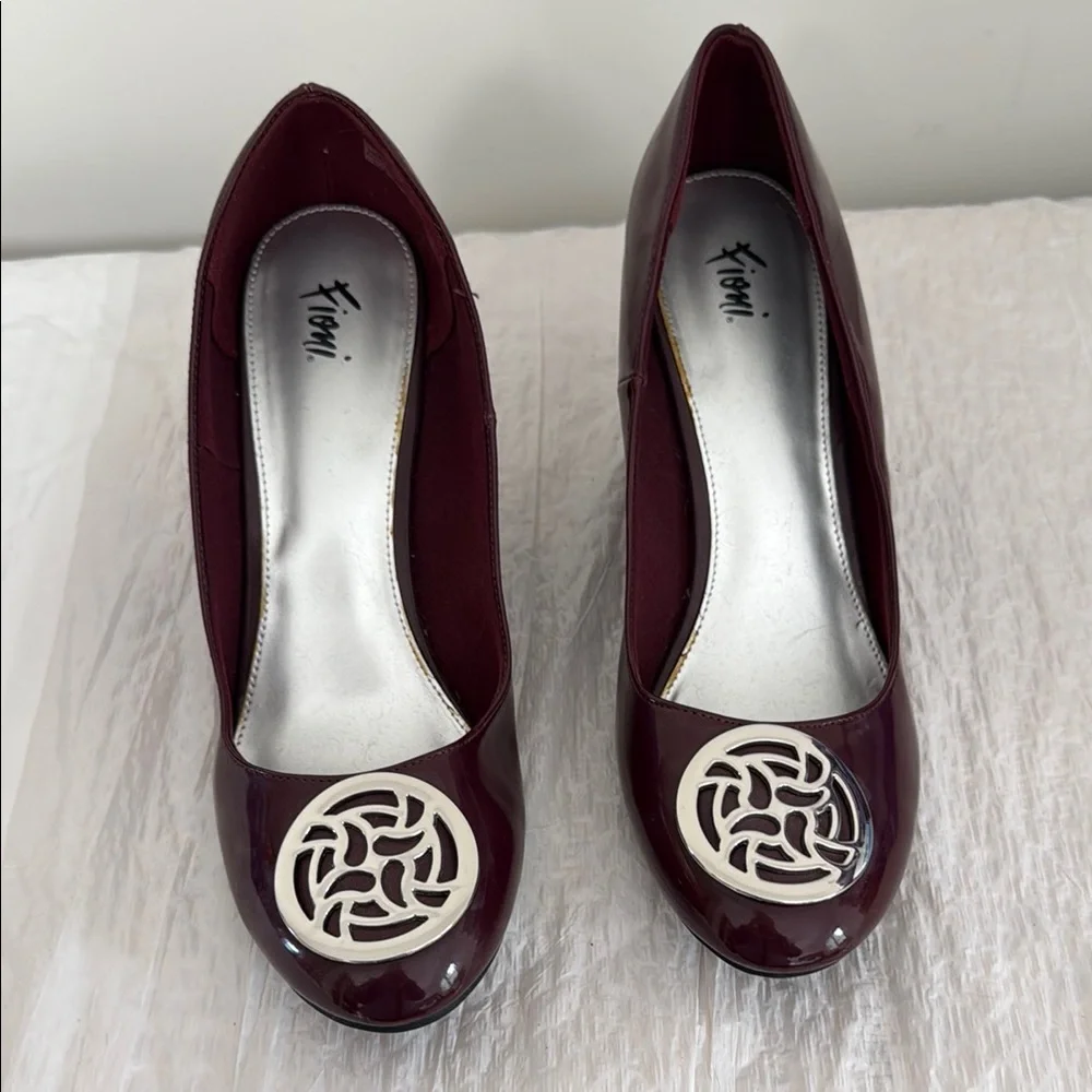FIONI Clothing Burgundy Wedge Pumps with Silver Emblem